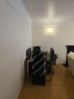 a dining room with a table and chairs in a room at Accessible Flat Greater London in Upminster