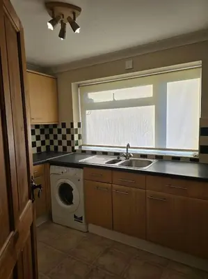 a kitchen with a sink and a washing machine at Accessible Flat Greater London in Upminster
