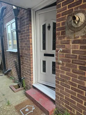a white door on the side of a brick building at Accessible Flat Greater London in Upminster