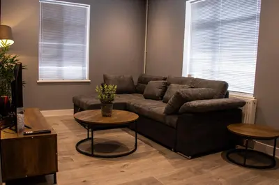 a living room with a couch and two tables at Comfortable 3 bed house in central location, Stevenage in Stevenage