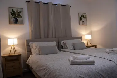 a bedroom with a bed with towels on it at Comfortable 3 bed house in central location, Stevenage in Stevenage