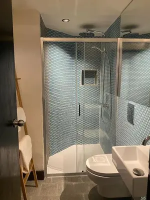 a bathroom with a shower and a toilet and a sink at Cambridgeshire Wabi-sabi in Barrington