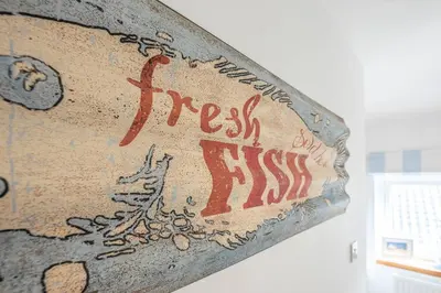 a sign that reads fresh six six on a wall at Beachcomber, Aldeburgh in Aldeburgh