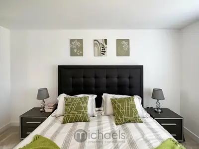 a bedroom with a bed with two night stands and two lamps at Colchester Spacious Double Rooms in CO4 in Mile End