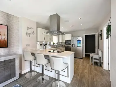 a kitchen with a counter and stools in it at Colchester Spacious Double Rooms in CO4 in Mile End