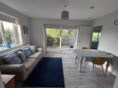 a living room with a couch and a table at Hamble House Holiday Let in Woodbridge