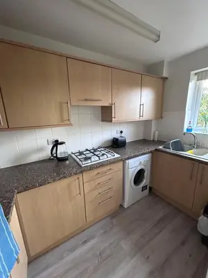 a kitchen with a stove and a washing machine at Hamble House Holiday Let in Woodbridge