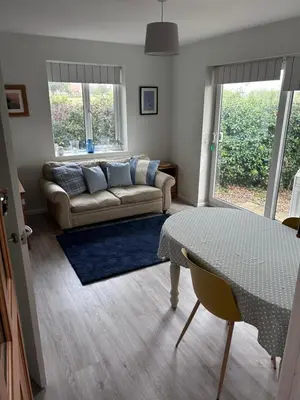 a living room with a couch and a table at Hamble House Holiday Let in Woodbridge