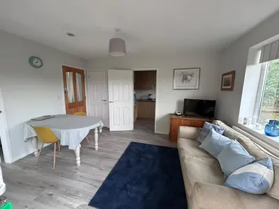 a living room with a couch and a table at Hamble House Holiday Let in Woodbridge