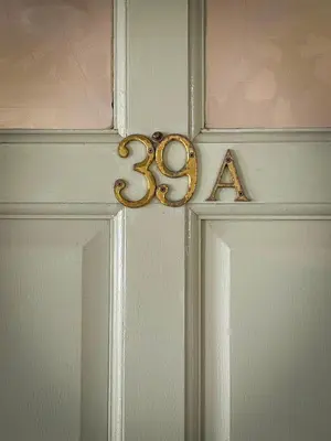 a door with the number thirtythree on it with a door knob at The Falcon's Nest - Central in Bury Saint Edmunds
