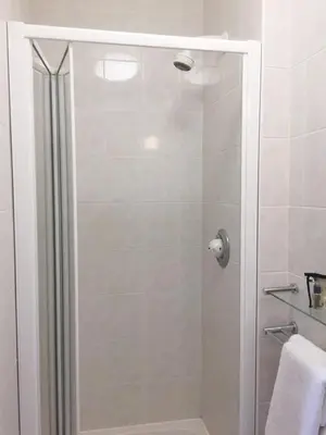 a shower with a glass door in a bathroom at Arundel House Hotel in Cambridge