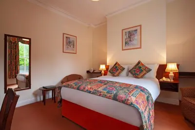 a hotel room with a bed and a window at Arundel House Hotel in Cambridge