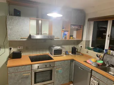 a kitchen with a sink and a microwave on a counter at At Apex House single room in Horndon on the Hill