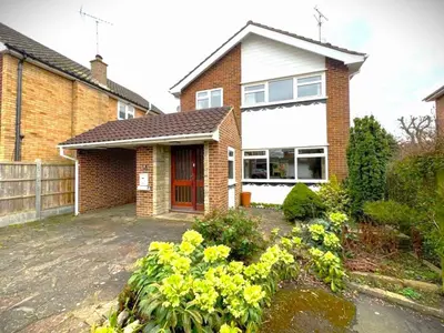 a brick house with a red door and some flowers at Scandi inspired holiday home Brentwood in Brentwood