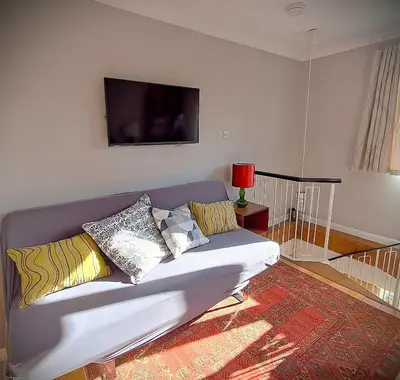 a living room with a couch with pillows on it at Scandi inspired holiday home Brentwood in Brentwood