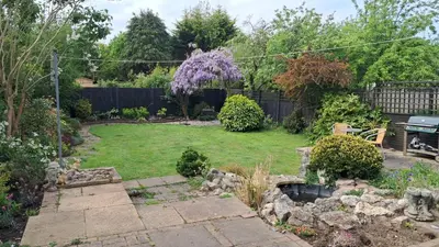 a backyard with a garden with a pond at Scandi inspired holiday home Brentwood in Brentwood