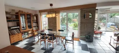 a dining room with a glass table and chairs at Scandi inspired holiday home Brentwood in Brentwood