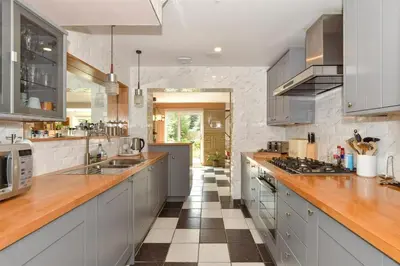 a large kitchen with wooden counter tops and stainless steel appliances at Scandi inspired holiday home Brentwood in Brentwood