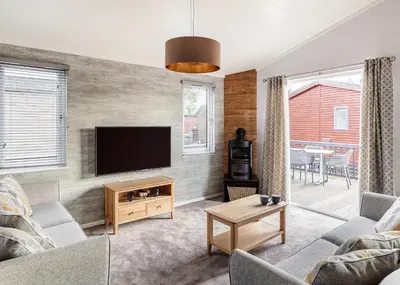 a living room with a flat screen tv on a wall at Roydon Marina Village in Roydon