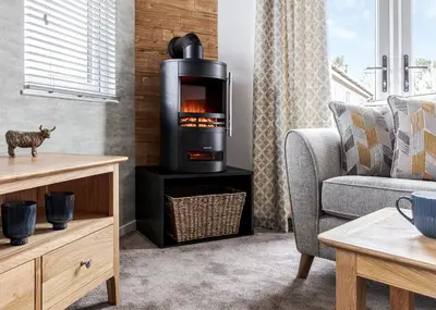 a living room with a fireplace in the wall at Roydon Marina Village in Roydon