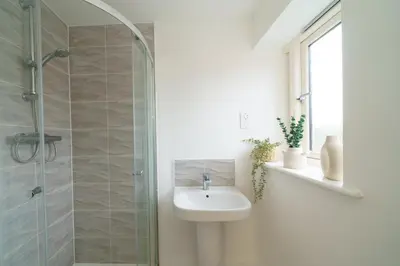 a bathroom with a sink and a shower at Riverside Haven in Woodbridge in Woodbridge
