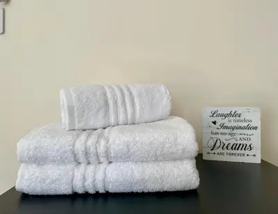 a stack of towels sitting on top of a table at New Luxury flats in Ipswich
