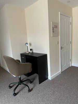 a desk and a chair in a room at New Luxury flats in Ipswich