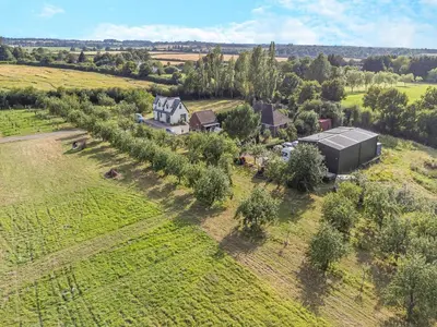 an aerial view of a farm with a building and trees at Shepherd's Retreat in Ongar