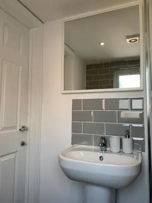a bathroom with a sink and a mirror at Cosy Studio Apartment in Leigh-on-Sea, Close to Bell Wharf Beach & Adventure Island in Leigh-on-Sea