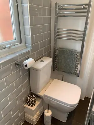 a small bathroom with a toilet and a window at Cosy Studio Apartment in Leigh-on-Sea, Close to Bell Wharf Beach & Adventure Island in Leigh-on-Sea