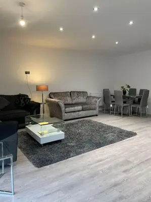 a living room with a couch and a table at 1 Bedroom Apartment By Brookland Stays Serviced Accommodation Short Lets Essex With Free WIFI in Brentwood