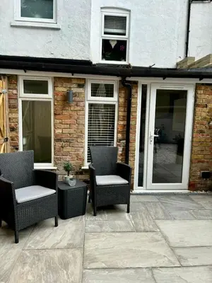 a patio with two chairs and a table at Stylish and Chic Seaside Apartment in Southend-on-Sea