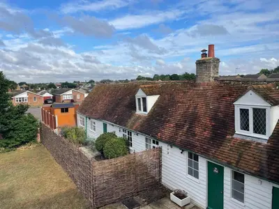 an overhead view of a white house with a red roof at Cozy One-Bedroom Cottage in Great Tey in Great Tey