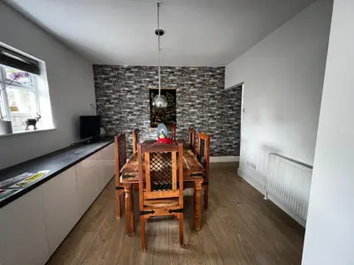 a dining room with a wooden table and chairs at Cozyleigh in Southend-on-Sea