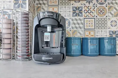 a coffee maker sitting on a shelf next to cups at Rayleigh Weir - Luxury 3 bedroom house with games room in Rayleigh