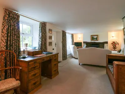 a room with a desk and a living room at West View in Thetford
