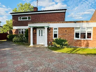 a brick house with a white door at Contractors families free parking Ramsey Road in St Ives