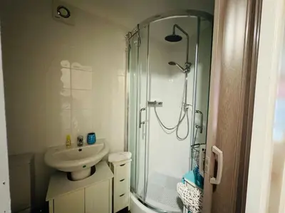 a bathroom with a glass shower and a sink at Contractors families free parking Ramsey Road in St Ives
