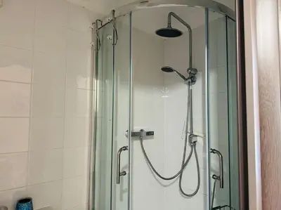 a shower in a bathroom with a glass shower stall at Contractors families free parking Ramsey Road in St Ives