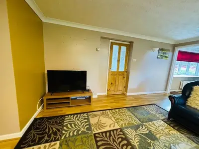 a living room with a flat screen tv and a couch at Contractors families free parking Ramsey Road in St Ives