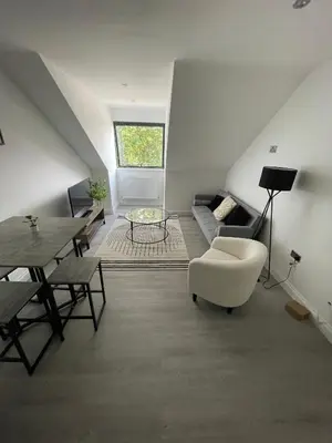 a living room with a couch and a table at Royal Oak Apartments 7 - Free Secure Parking - 2 Bedroom - Perfect for Contractors in Brentwood