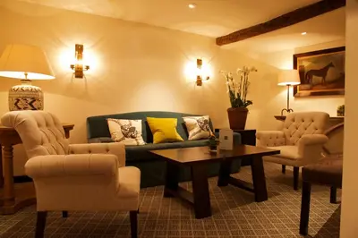 a living room with a couch and chairs and a table at Swan Hotel & Spa in Lavenham