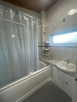 a bathroom with a tub and a sink and a shower at Truehome Close to Stansted Airport in Harlow
