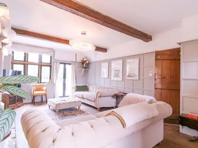 a living room with two couches and a table at Home by the Sea in Clacton-on-Sea