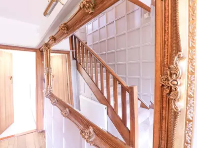 an ornate mirror next to a staircase in a house at Home by the Sea in Clacton-on-Sea