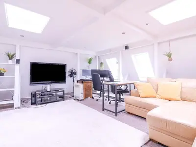 a living room with a couch and a table at Home by the Sea in Clacton-on-Sea