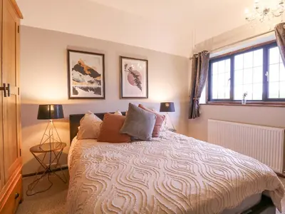 a bedroom with a bed with pillows on it at Home by the Sea in Clacton-on-Sea