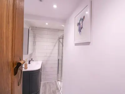 a bathroom with a sink and a shower at Home by the Sea in Clacton-on-Sea
