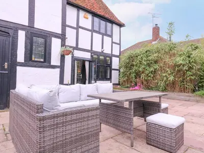 a sofa and a table in front of a house at Home by the Sea in Clacton-on-Sea