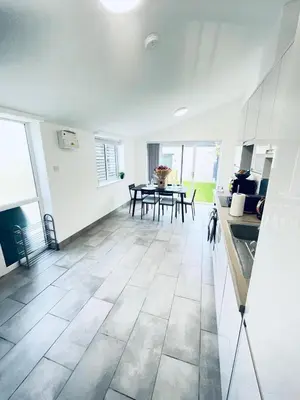 a kitchen and dining room with white walls and tile floors at 2 Bed Flat - Sleeps 5 - Parking - Wifi in Cambridge